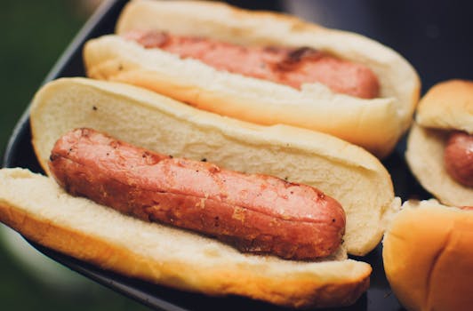 Delicious grilled hot dogs in buns, perfect for summer picnics and barbecues.