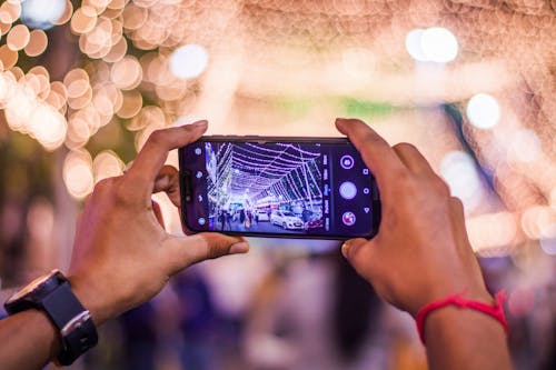 Free Photo of Person's Hands Holding Smartphone Stock Photo