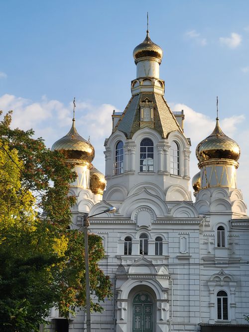 Free Beautiful Russian Orthodox church with golden domes against a blue sky. Stock Photo