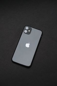 An elegant smartphone on a dark background, emphasizing modern tech design.