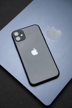 Stylish Apple iPhone on a MacBook, showcasing modern technology and design.