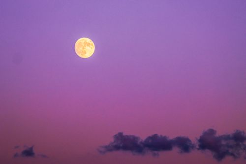 Free Full moon in a vibrant purple sky over Naxos, Greece, creating a dreamy nightscape. Stock Photo