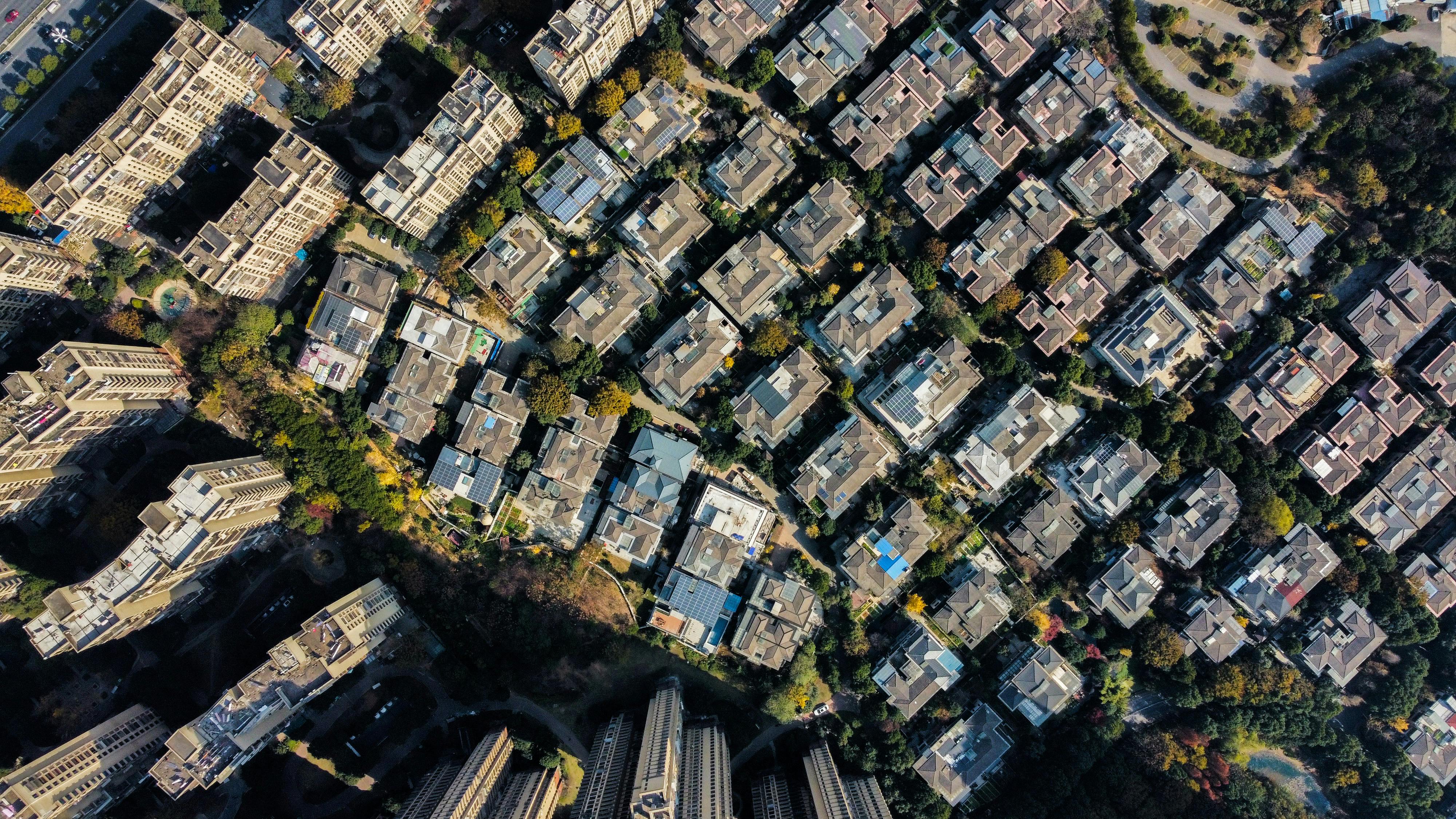 Aerial shot showcasing a densely packed urban residential neighborhood in daylight.