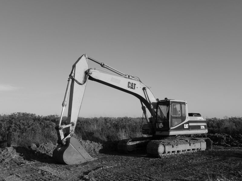 Excavator and heavy equipment working on a factory floor rebuild site - Klang Factory Floor Rebuild by Solidcraft Builders