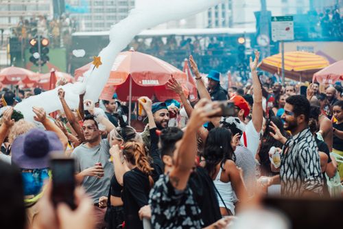 Free Crowds enjoying a lively outdoor carnival with music and festivities. Stock Photo