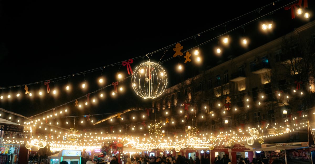 Vibrant night market scene in Baku with decorative lights and holiday ambiance.