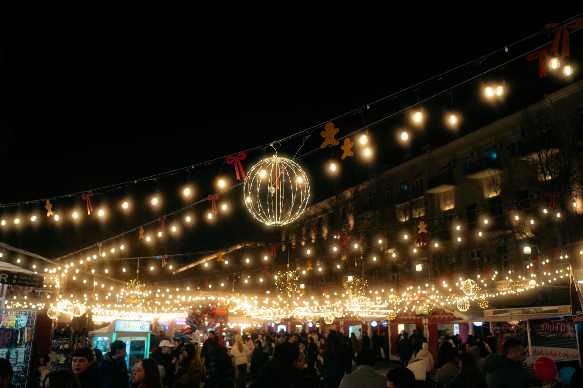 Vibrant night market scene in Baku with decorative lights and holiday ambiance.