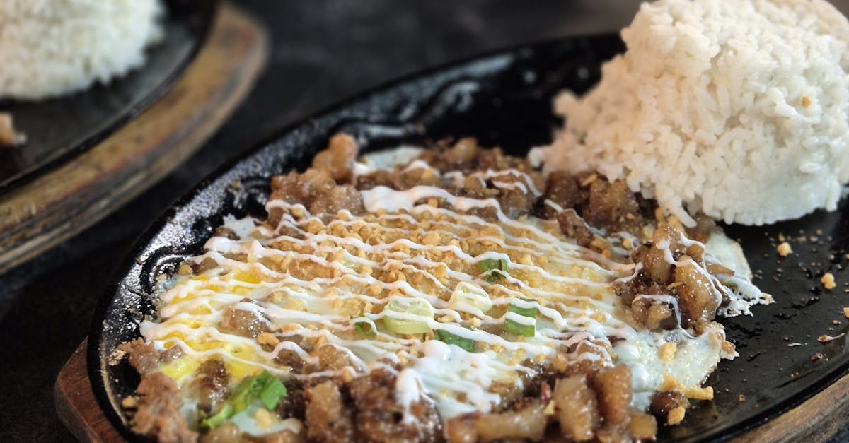 Sizzling Sisig with Steamed Rice on Hotplate · Free Stock Photo