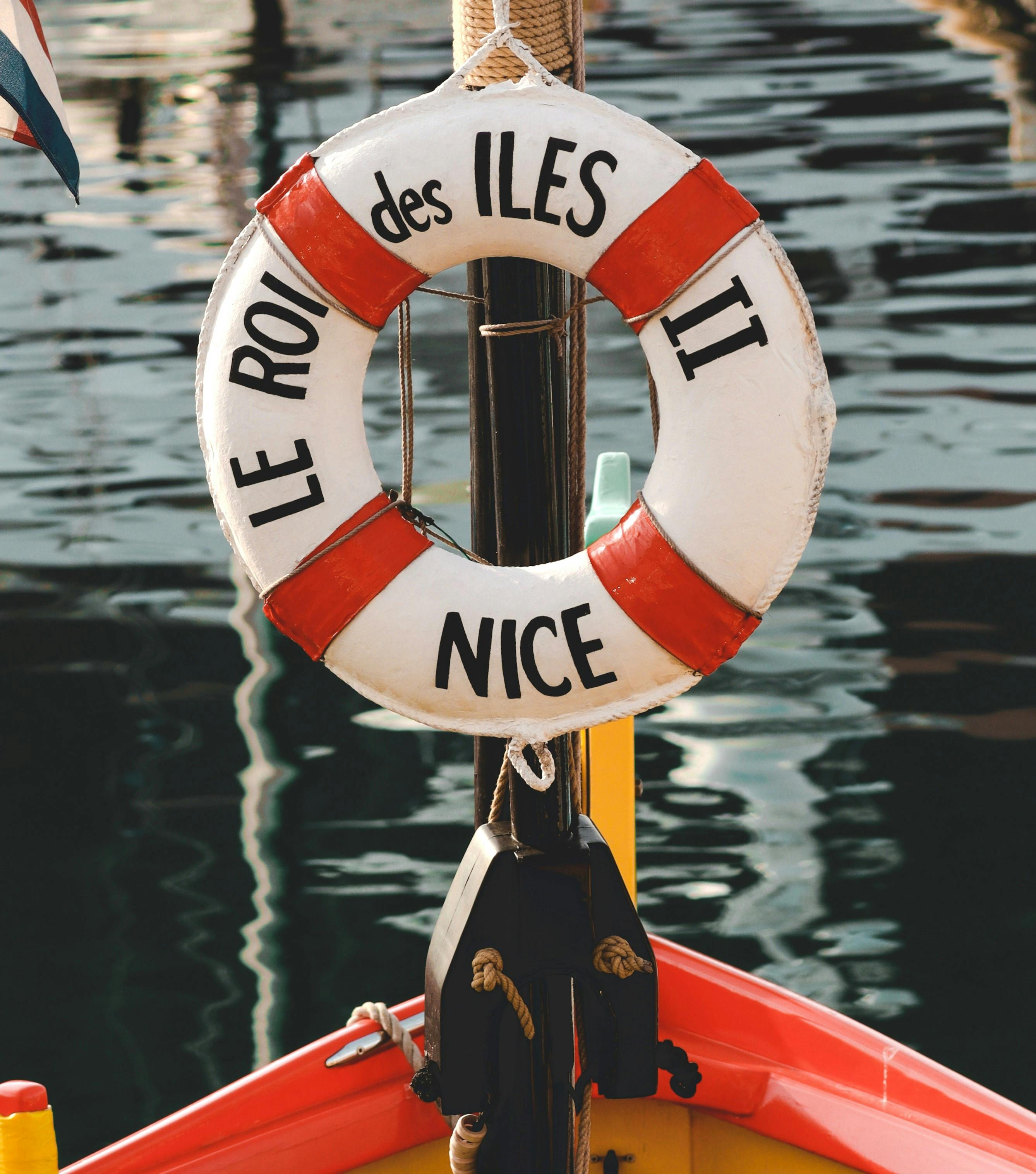 Life buoy with 'Le Roi des Iles Nice' on a boat in Nice harbor, France.