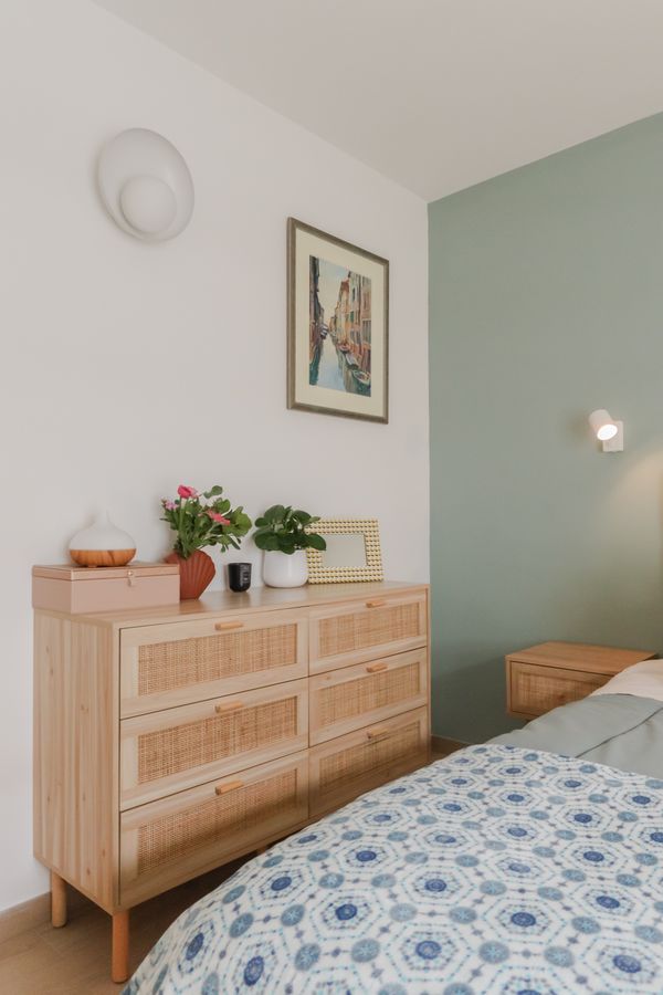 Wooden dresser styled with plants and framed art — photo by Elodie Astier on Pexels