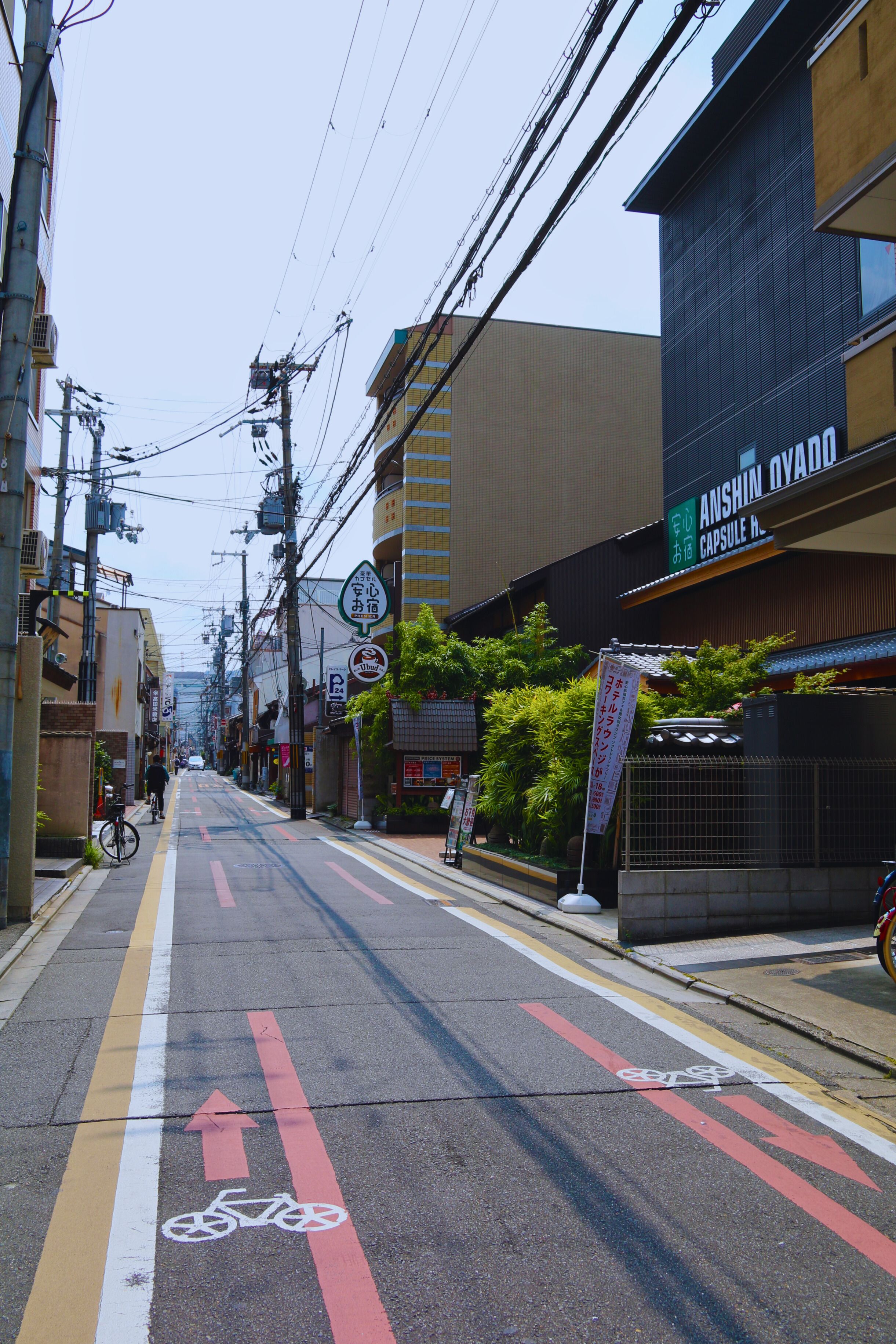 Tranquil street view in Kyoto, Japan, showcasing urban life and architecture.