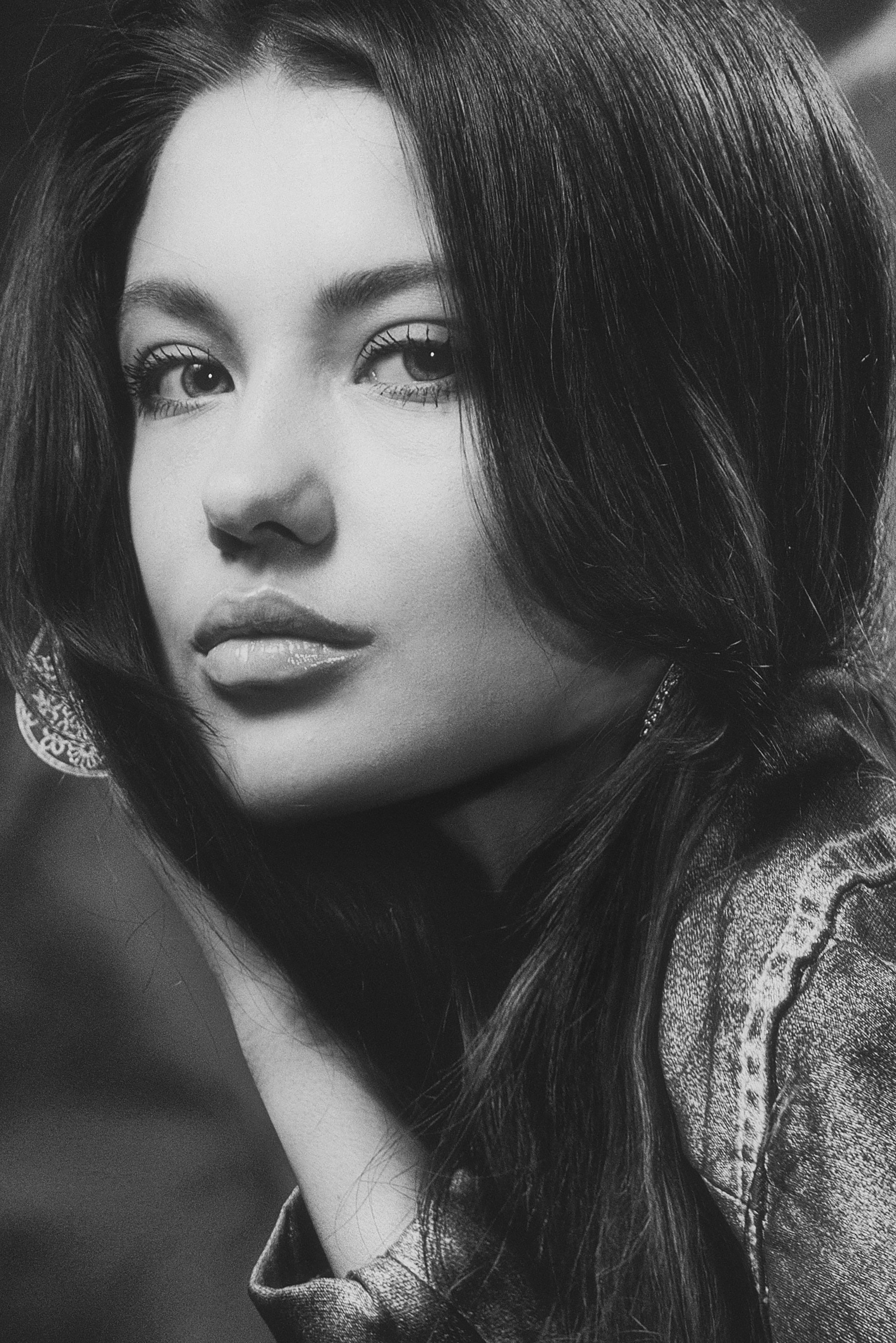 Striking black and white portrait of a young woman in denim.