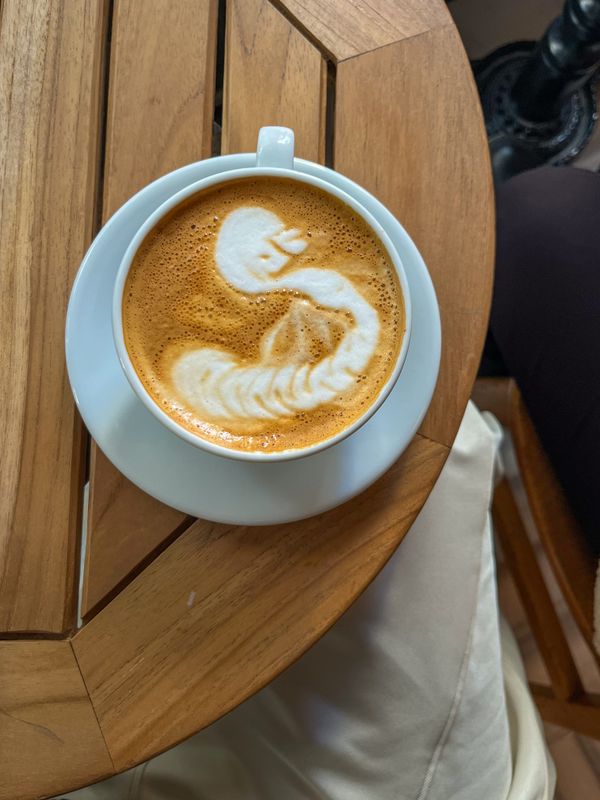 Latte art coffee on wooden table
