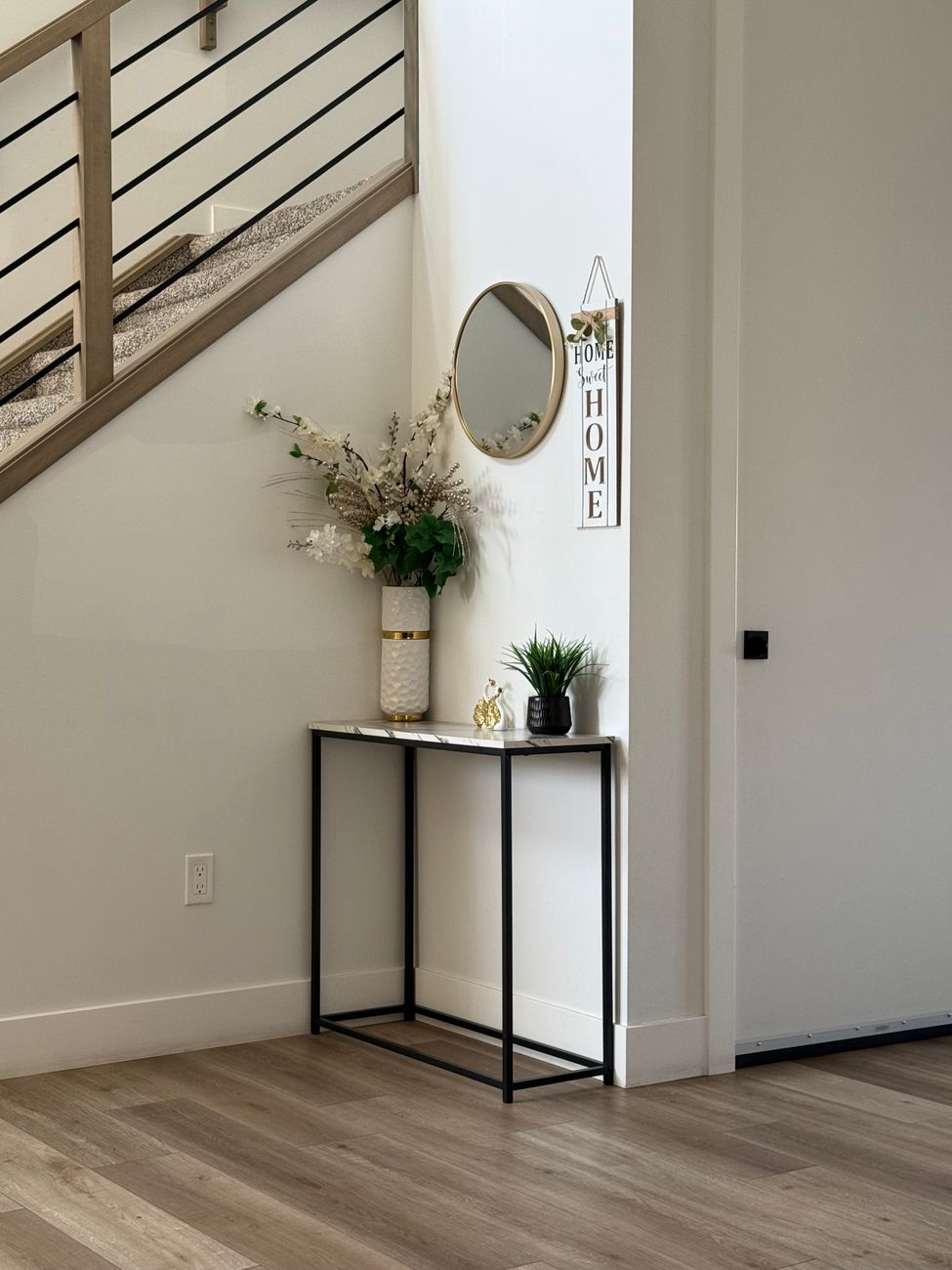Minimal home entryway with a console table styled as a landing spot for an arrangement