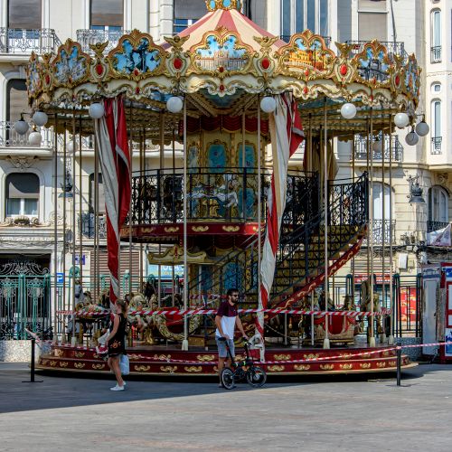 Free Charming carousel in Valencia's city square, showcasing vibrant colors and classic design. Stock Photo