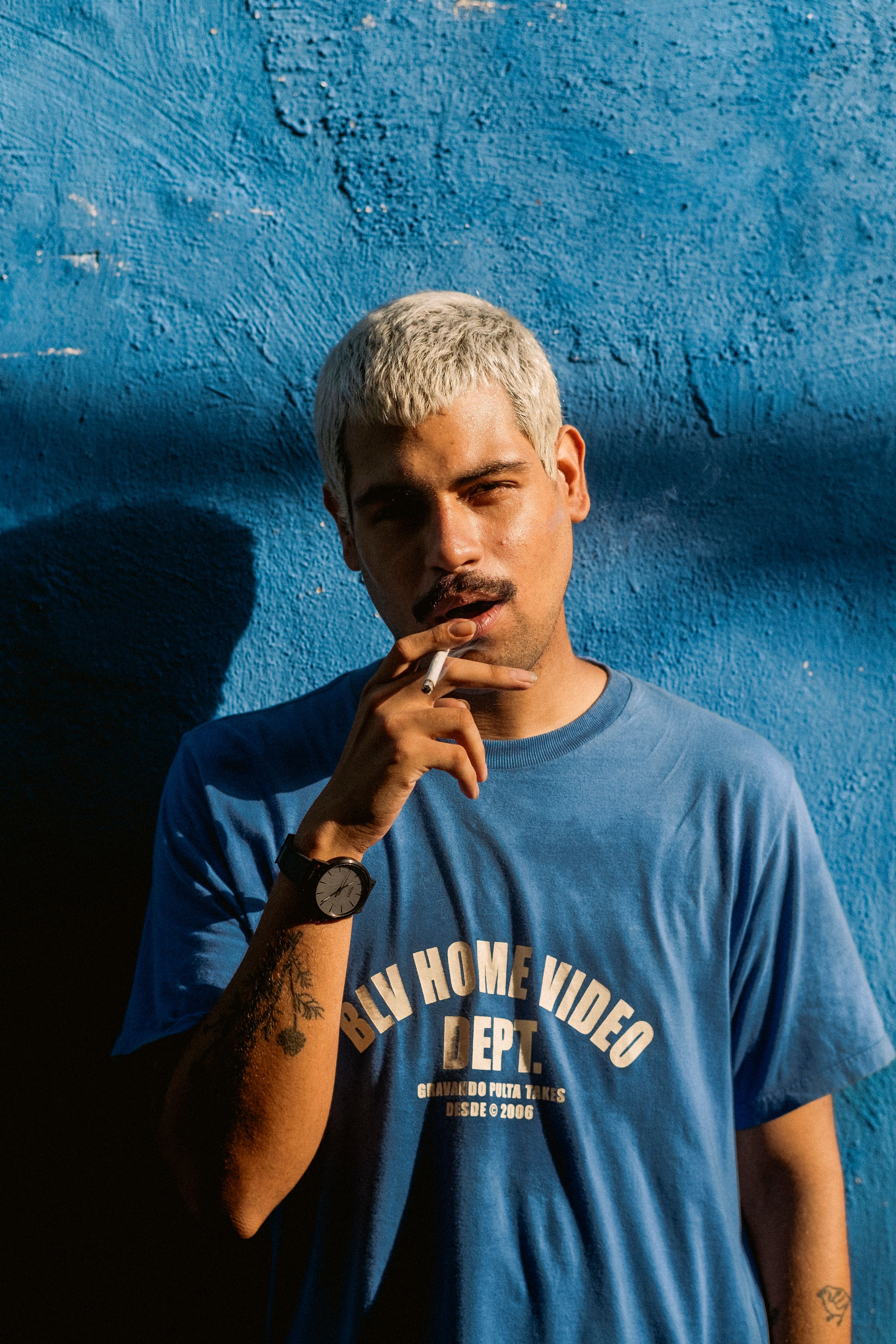 Casual Portrait of a Man Against Blue Wall · Free Stock Photo