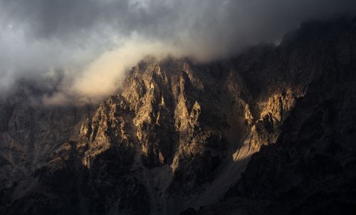 Free Stunning view of rugged mountain peaks emerging from the clouds, creating a dramatic landscape. Stock Photo