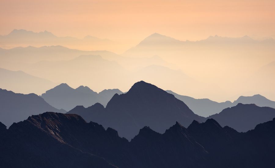 Layered mountain peaks silhouetted at sunset by Marek Piwnicki on Pexels