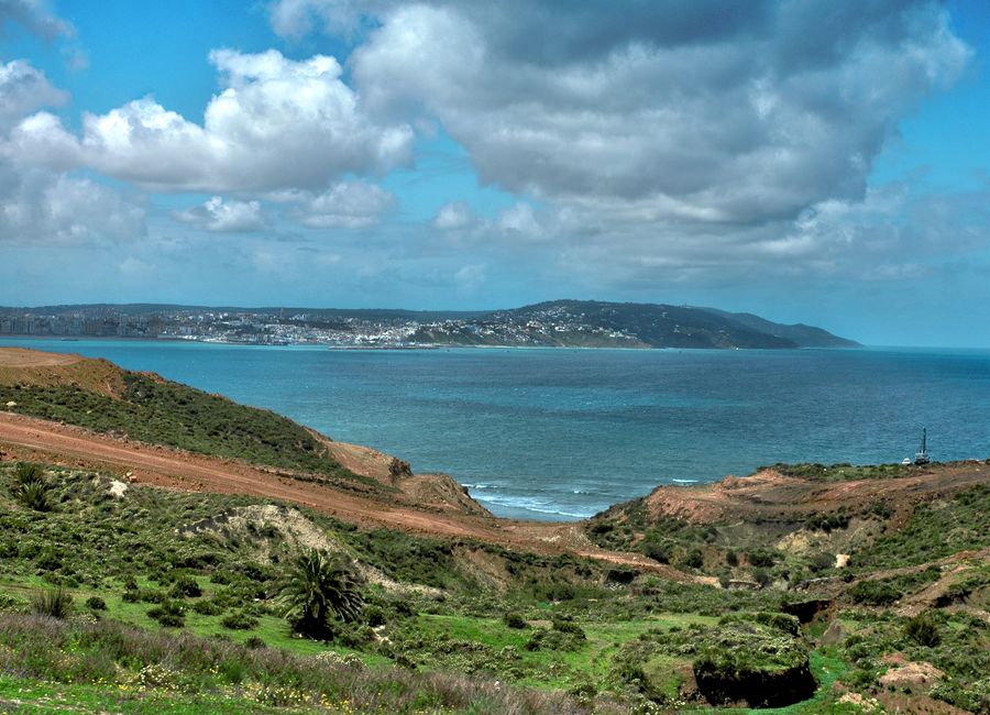 Stunning coastal landscape of Tangier, Morocco with lush greenery and blue sea.