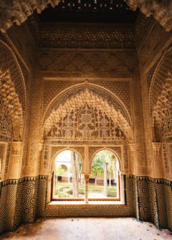 Stunning intricately carved Moorish archways inside the Alhambra Palace in Granada, Spain, showcasing Islamic art.