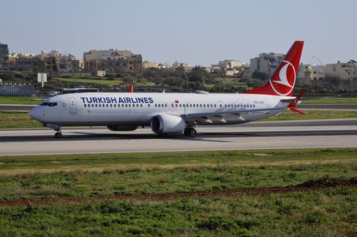 Free Turkish Airlines Boeing 737 taxiing on runway at a sunny airport day. Stock Photo