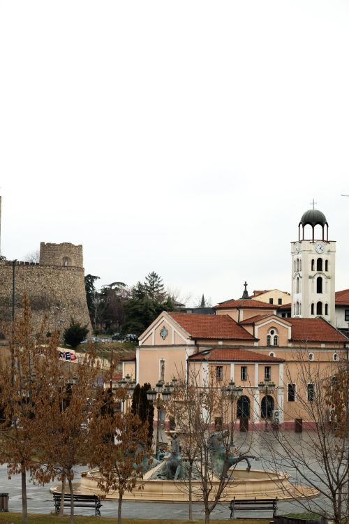Free Scenic view of a historic church and ancient tower in North Macedonia's urban landscape. Stock Photo