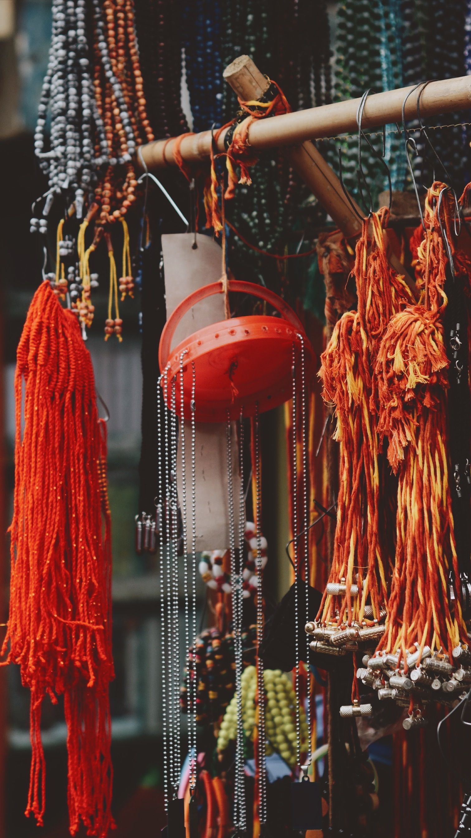 Vibrant display of traditional beaded jewelry in a market setting, showcasing diverse colors and textures.