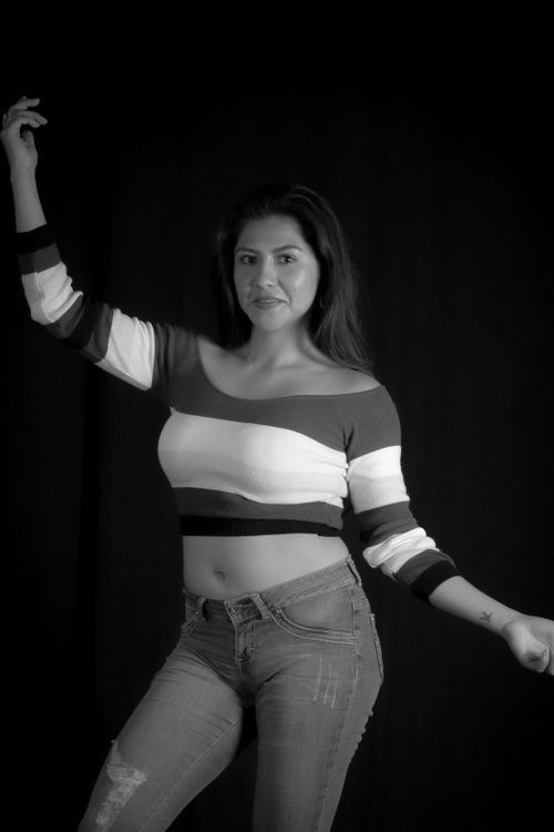 Free A stylish woman poses confidently in a studio, showcasing modern fashion trends. Stock Photo