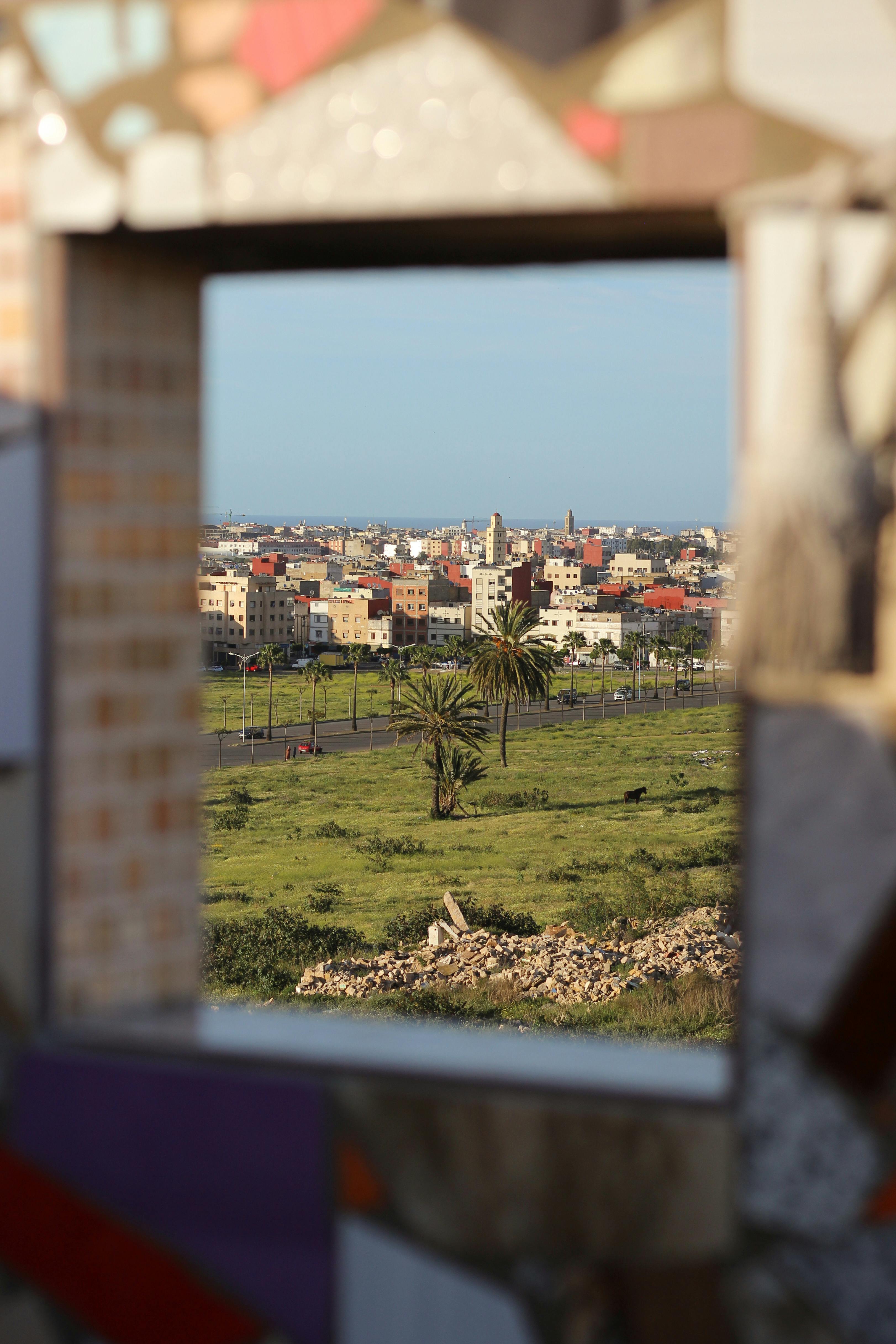 A vibrant cityscape of Casablanca from an artistic window frame perspective.