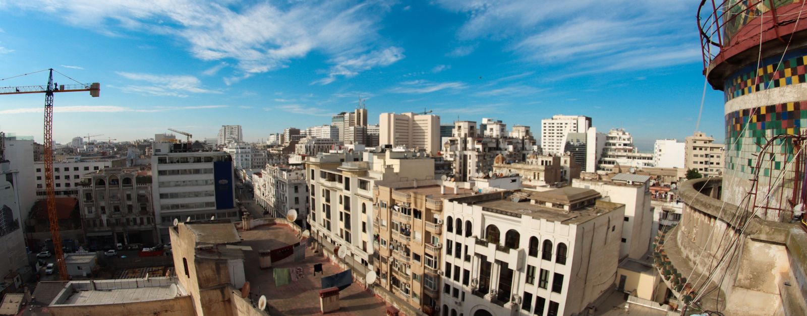 High-angle view of Casablanca's urban skyline under a vibrant blue sky.