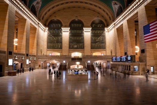 Grand Central Terminal's vast interior captured at night, highlighting its architectural grandeur and bustling atmosphere.
