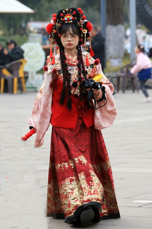 Free Woman in traditional Chinese attire poses outdoors, embodying cultural heritage. Stock Photo