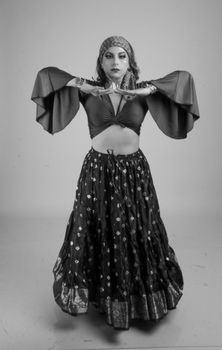 Graceful woman performing in traditional attire, expressing cultural art.