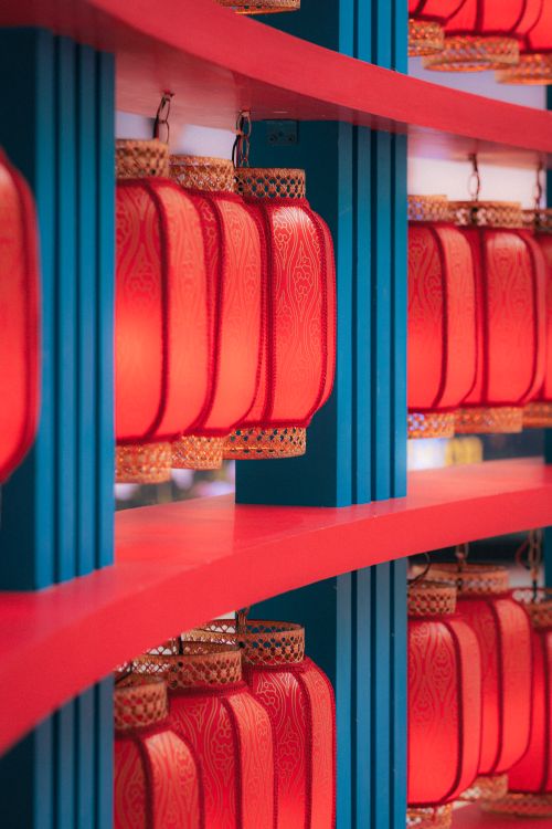Free Red lanterns line a vibrant blue and red display, symbolizing celebration and heritage. Stock Photo