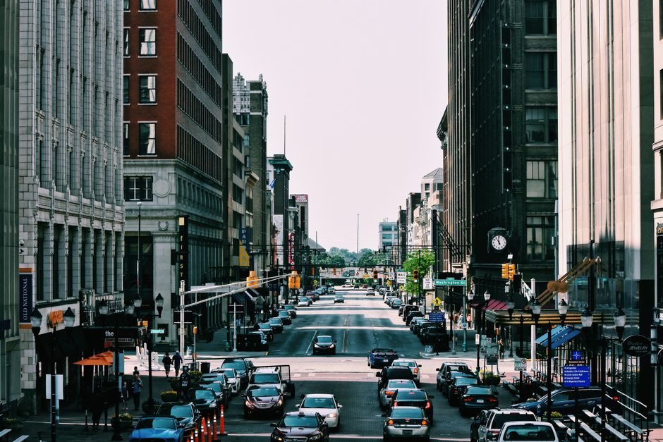Vibrant city street with heavy traffic and towering buildings in daylight