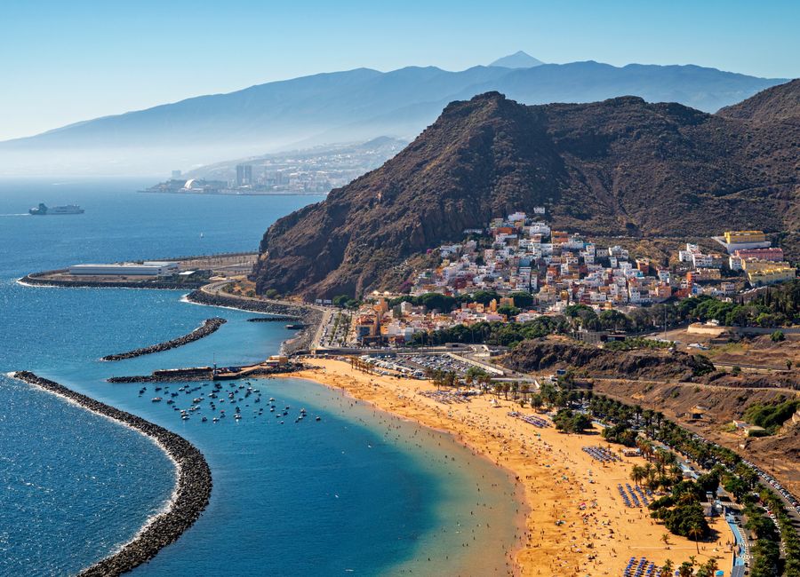 Stunning aerial view of Playa de Las Teresitas in Tenerife with mountainous backdrop.