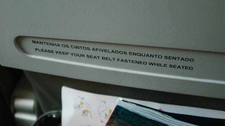 Close-up Of Aviation Policy On The Back Of An Airplane Seat