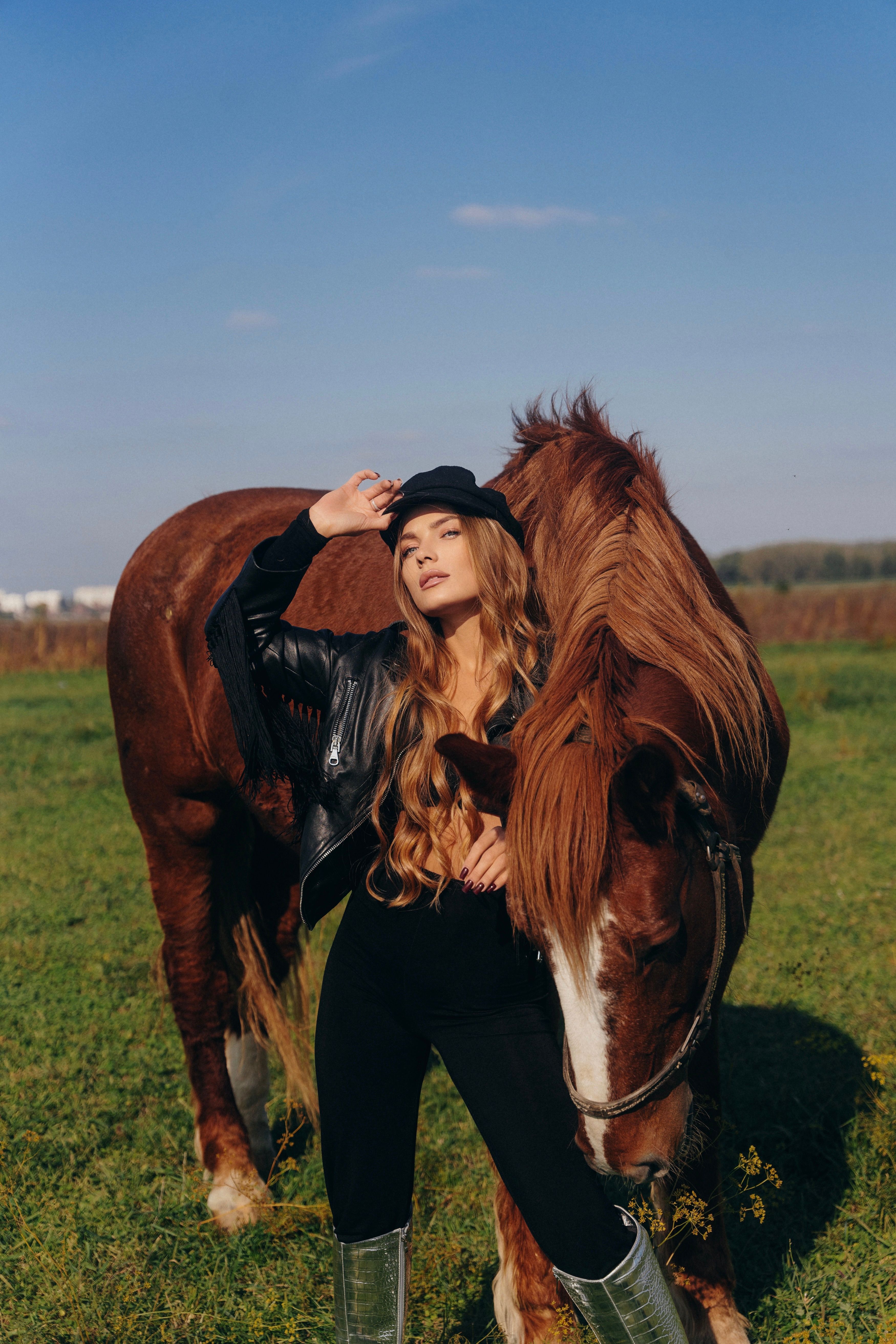 Woman in a Bodysuit Posing on a Field with a Horse · Free Stock Photo