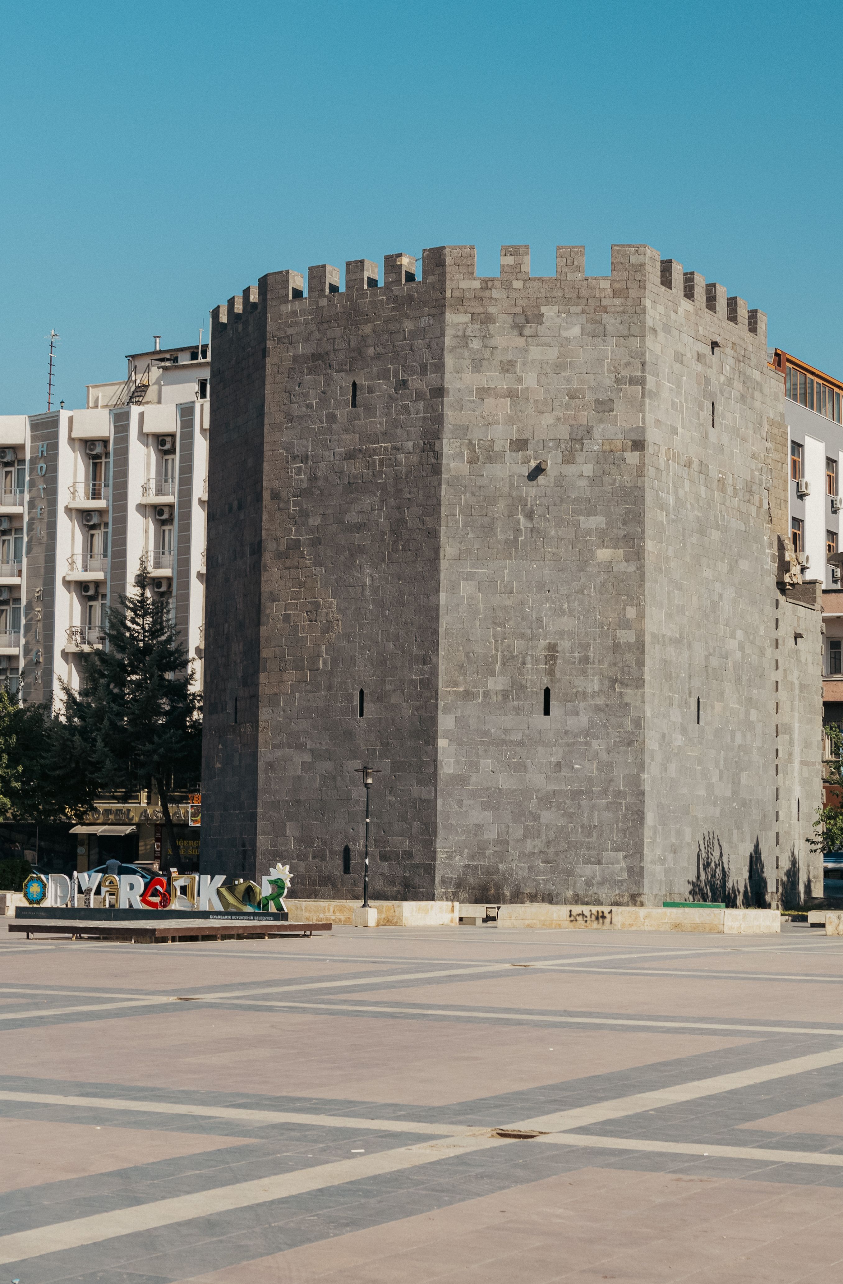 Historical Stone Tower in Urban Square Under Blue Sky · Free Stock Photo