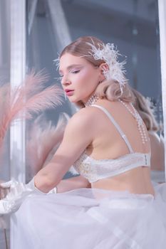 Portrait of a woman in white lingerie and pearl accessories, exuding elegance.