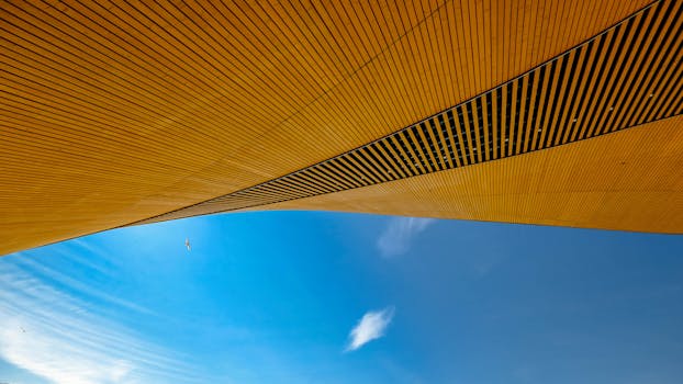 Abstract view of modern architecture with wooden textures in Helsinki, Finland under a clear blue sky.