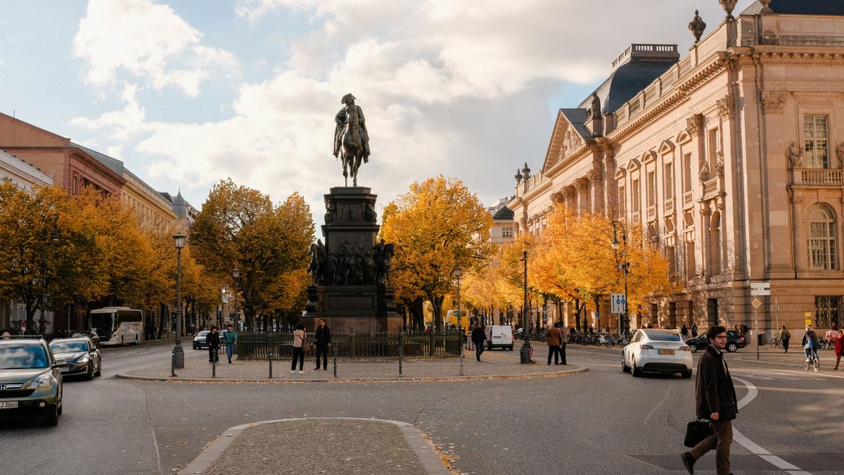 Historic Berlin street lined with trees in autumn colours
