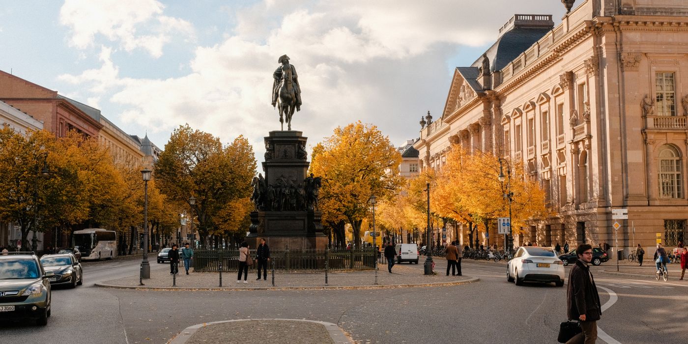 Autumn street scene in a European city with historic buildings and turning leaves