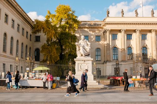 Free Street scene at Humboldt University with market stalls and pedestrians in Berlin. Stock Photo