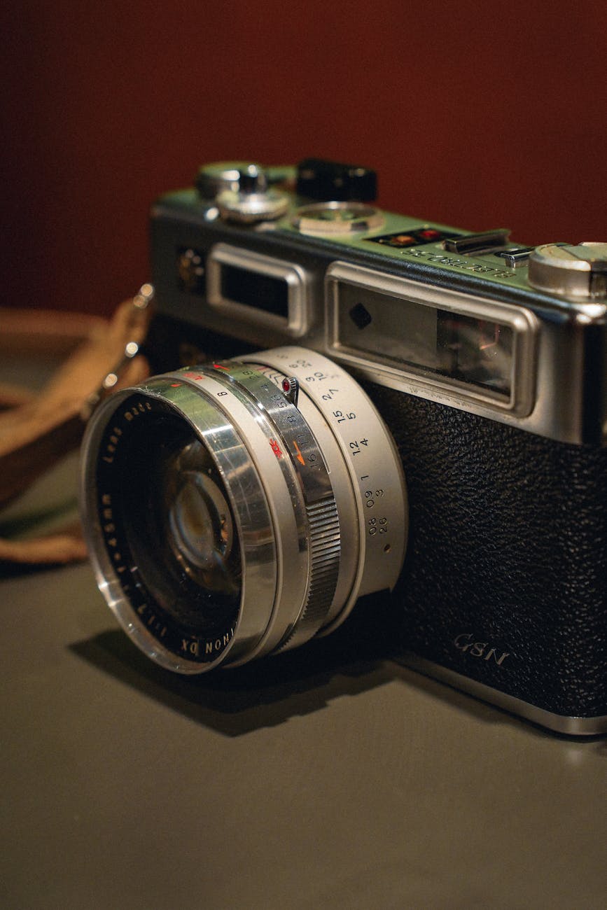 Close-up of a classic vintage film camera with a leather strap, featuring a retro design.
