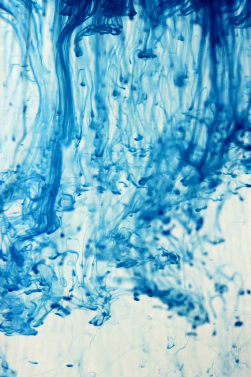 Free Captivating abstract image of blue ink swirling in water, creating dynamic patterns. Stock Photo
