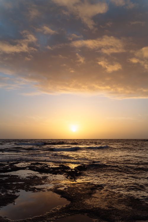 Free Experience the serene sunset over the tranquil waters of the Canary Islands, offering a perfect holiday destination. Stock Photo