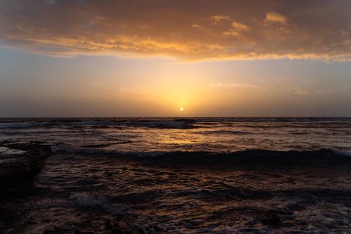 Free Tranquil sunset over the ocean in Tenerife, capturing golden hues and serene waves. Stock Photo