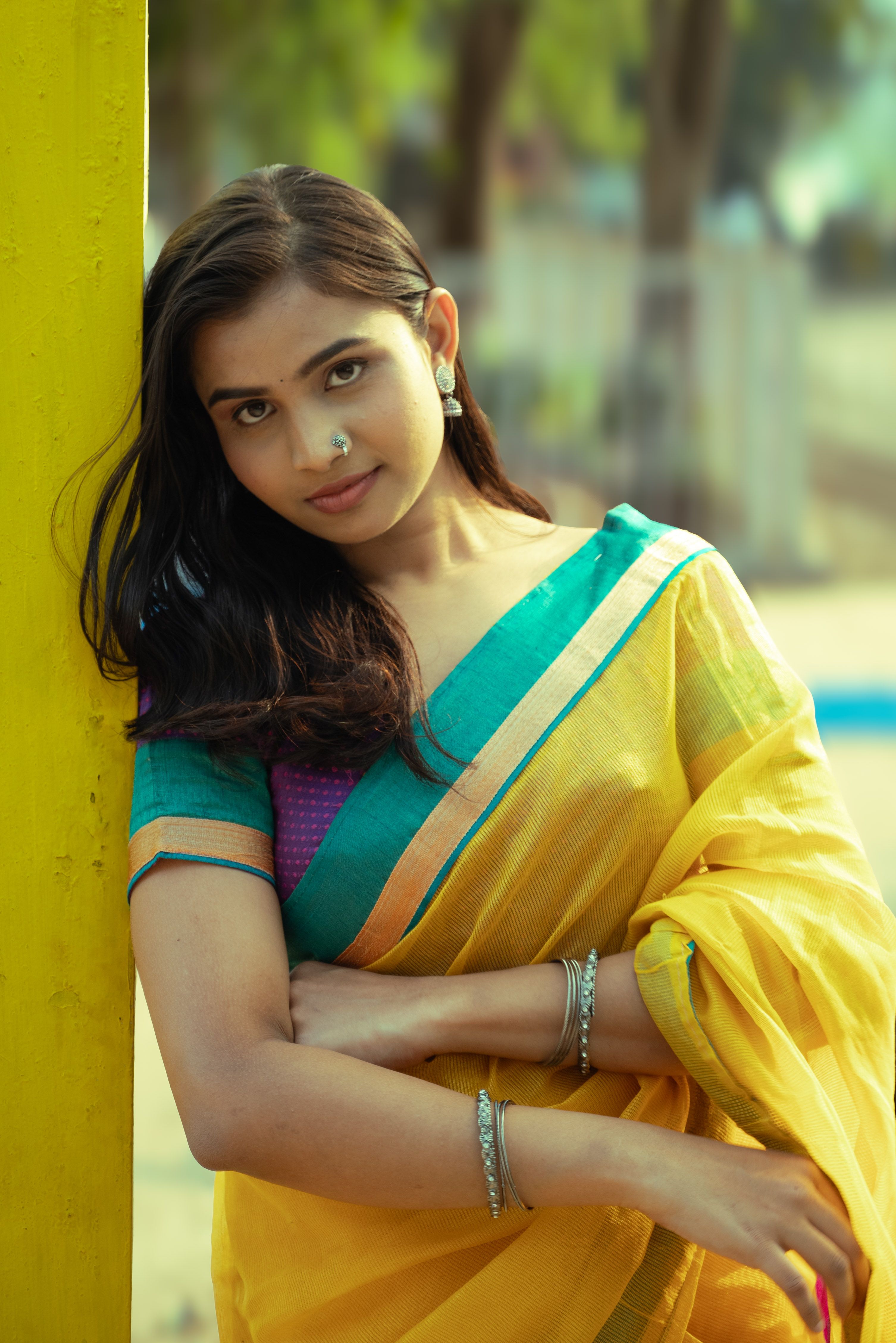 Young woman in vibrant yellow sari - perfect Nalangu guest outfit