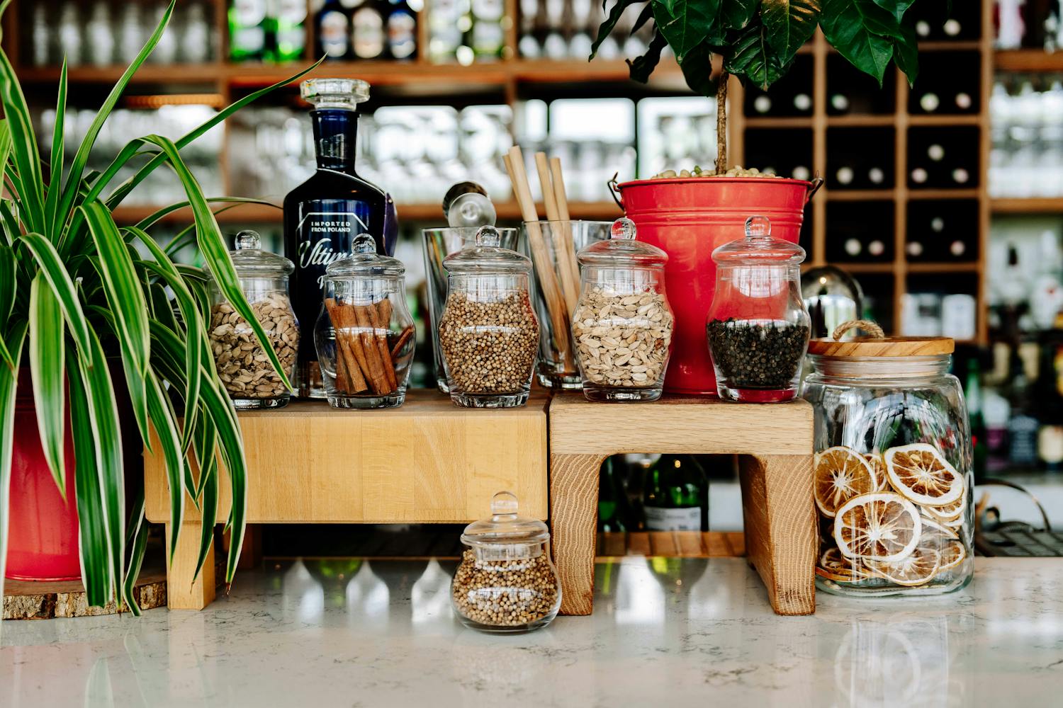 A vibrant assortment of spices and herbs elegantly arranged in glass jars at a market